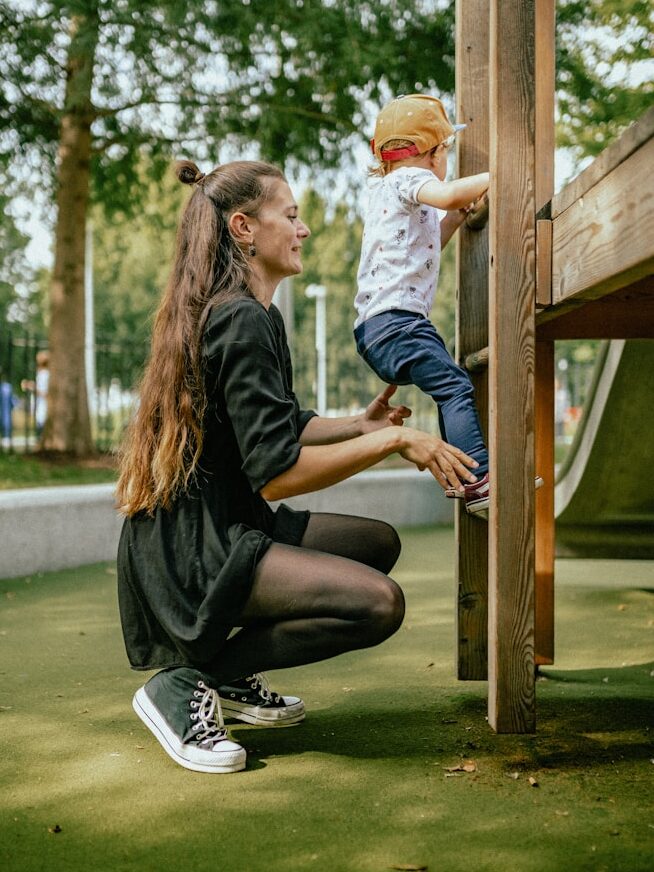 a man and a child playing on a playground
